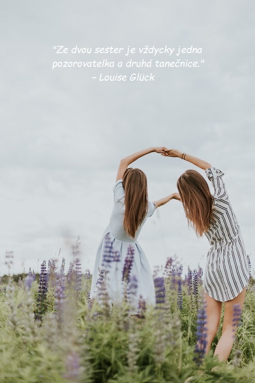 Dvě tancující dívky na louce s levandulí s citátem pro sestru od Louise Glück.
