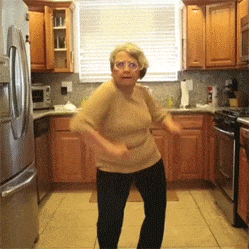 GIF přání k svátku tančící tety v kuchyni. 