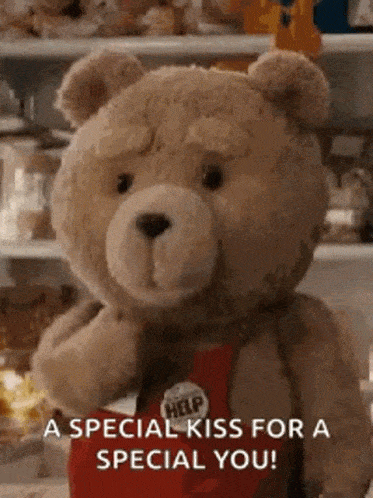 GIF přáníčko k svátku s medvídkem posílající pusu.